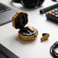 CTRL8 X35 true wireless earbuds in yellow variant displayed with charging case on a desk setup featuring a laptop, keyboard, and accessories