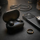 CTRL8 A6S wireless earbuds in sleek black charging case placed on a leather surface alongside premium accessories.