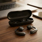CTRL8 X29 open-ear headphones with ergonomic design and charging case on a wooden desk