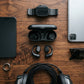 CTRL8 X29 open-ear headphones with charging case placed among premium gadgets for a stylish audio setup