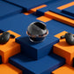 CTRL8 T2 over-the-ear earbuds with UNBLOQ technology and ergonomic design displayed on a geometric blue and orange background